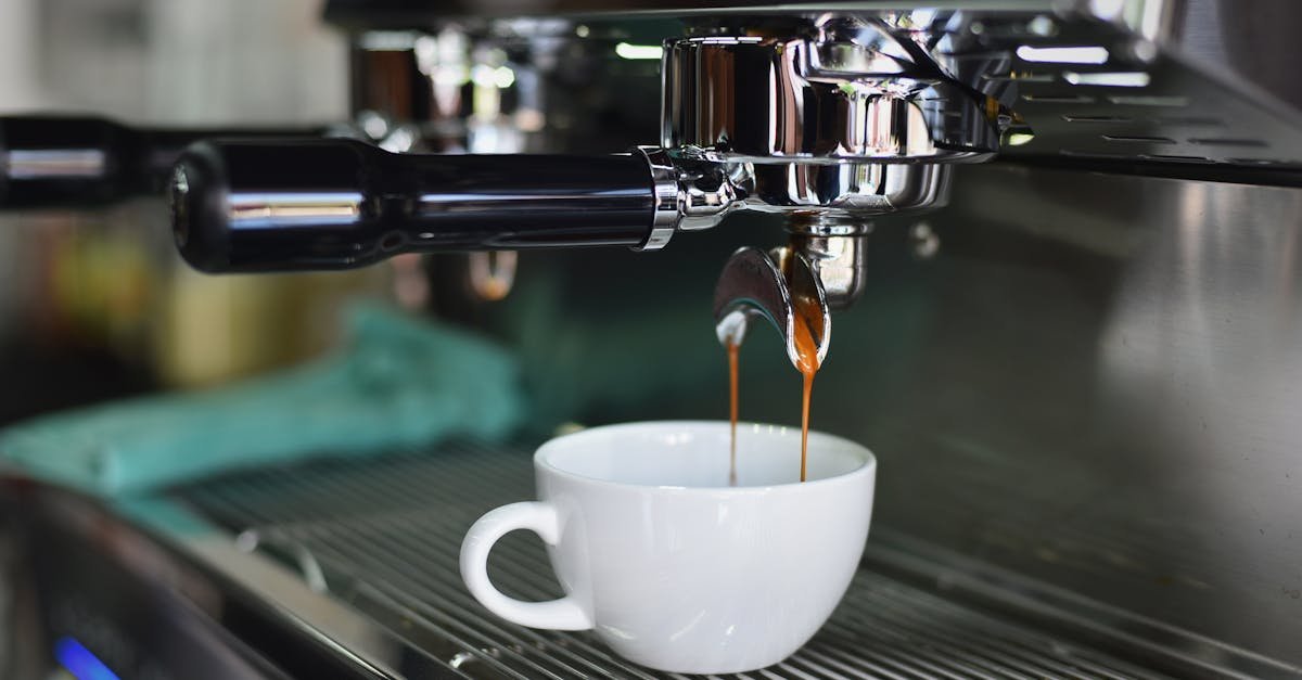 Close-up of espresso pouring from a shiny coffee machine into a white cup, perfect for lovers of caffeine and barista art.